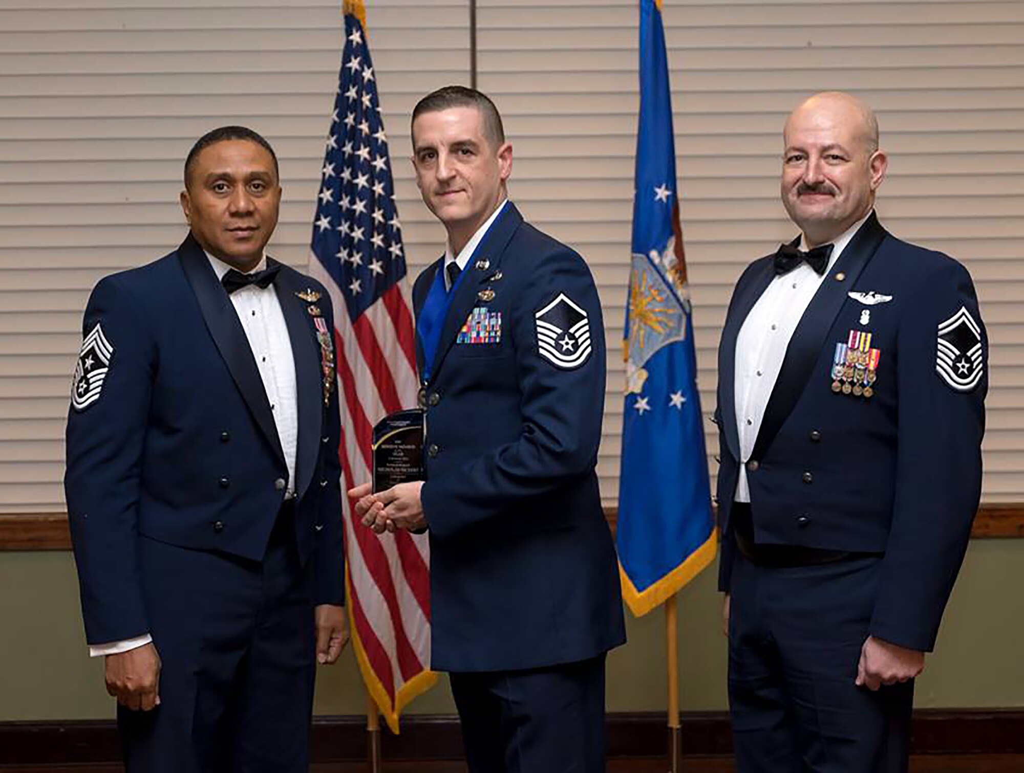 Master Sgt. Nicholas Nickert, 445th Aircraft Maintenance Squadron avionics technician, receives the 2016 Air Force Sergeants Association Kittyhawk Chapter 751 Reserve Member of the Year award at the AFSA annual awards banquet January 21, 2017. He is joined by Chief Master Sgt. James Felton, 445th Airlift Wing command chief and Senior Master Sgt. David McCoy, Kittyhawk Chapter 751 president. He was presented this award for his outstanding contributions both on and off duty. (Courtesy photo)