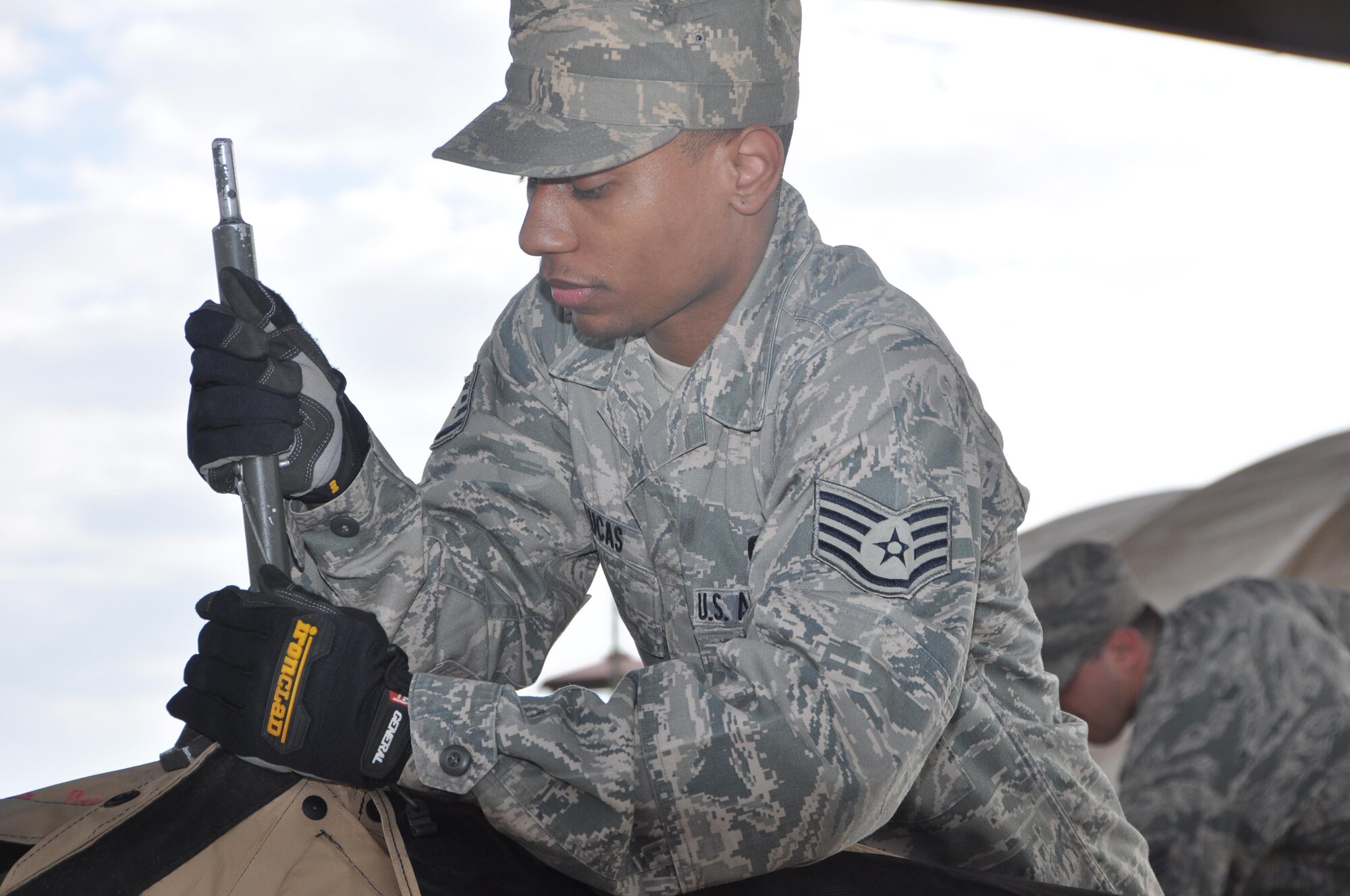 Staff Sgt. Trayunne Lucas of the 908th Airlift Wing’s Force Support Squadron helps assemble a combat kitchen during the Hennessy Competition Feb. 11 at Maxwell Air Force Base. The 908th is one of four teams competing for the John L. Hennessy Award that recognizes those who best excel in food service. (U.S. Air Force photo by Bradley J. Clark)