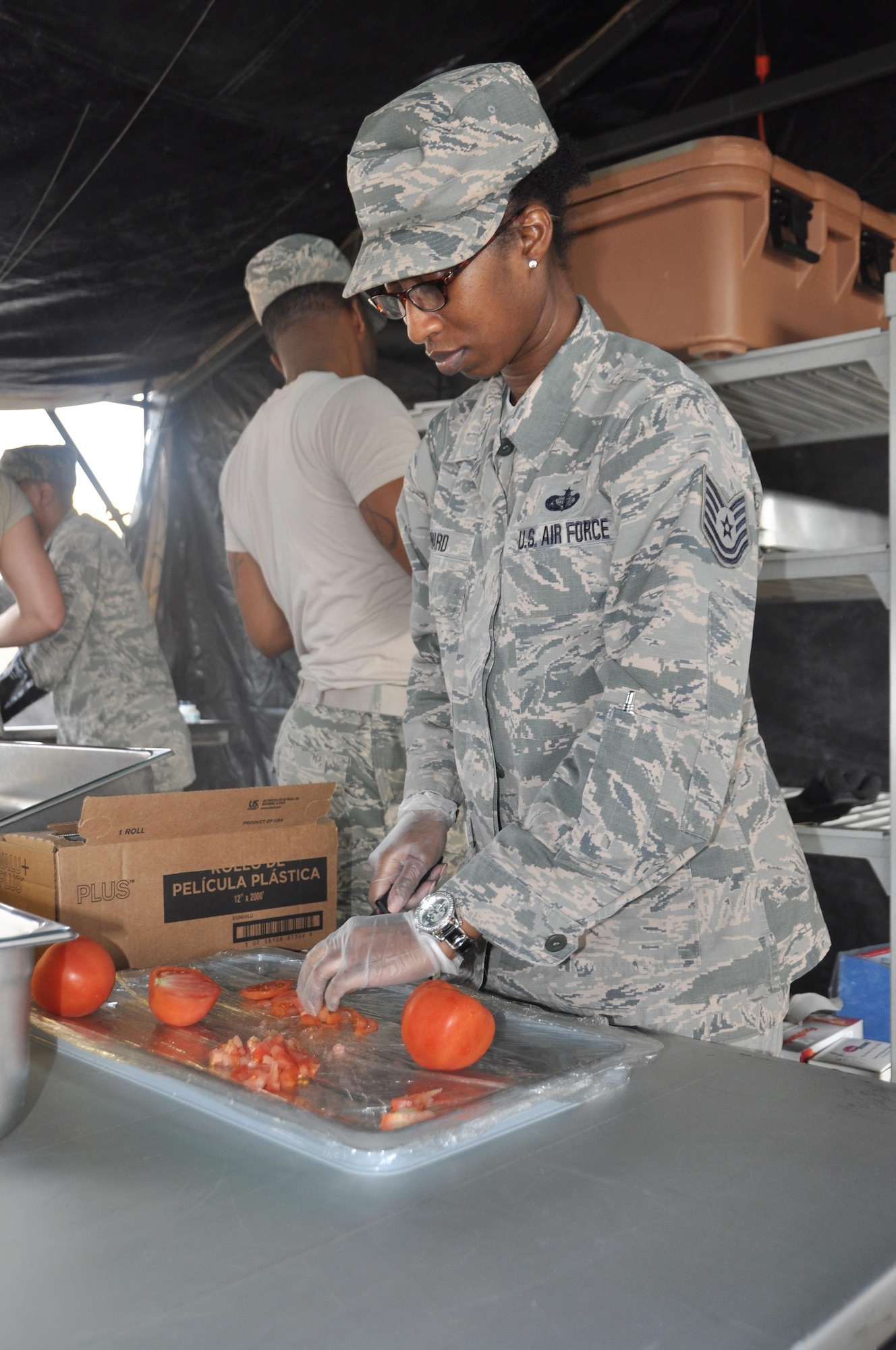 Member of the 908th Airlift Wing’s team during the Hennessy Competition, Tech. Sgt. Tekima Howard slices a tomato Feb. 11 at Maxwell Air Force Base. The 908th is one of four teams competing for the John L. Hennessy Award that recognizes those who best excel in food service. (U.S. Air Force photo by Bradley J. Clark)