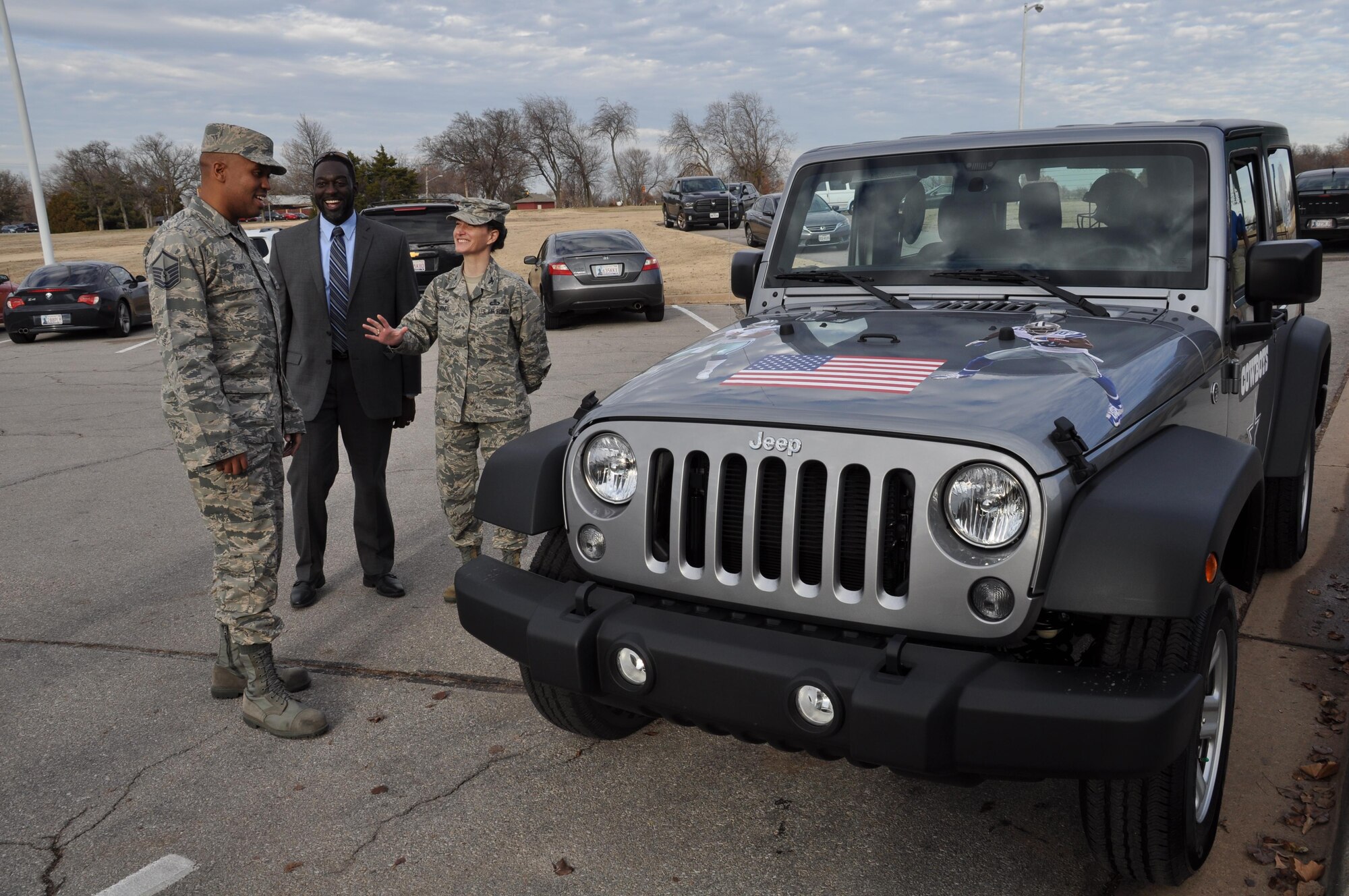 Master Sgt. Steven Pruitt, left, admires his new 2017 Jeep Wrangler, the grand prize in the Air Force Services Activity's Air Force Club Membership Giveaway, at Tinker Air Force Base, Oklahoma, Dec. 21, 2016. Col. Donna L. Turner, right, AFSVA commander, presented the keys at Pruitt’s squadron commander’s call. Pruitt, the NCO in charge of the Cyber Security Office, 552nd Air Control Network Squadron, entered the giveaway 20 times; his name was randomly generated from more than 11,000 entries. Standing with them is Jon Boyd, AFSVA club operations branch chief. 