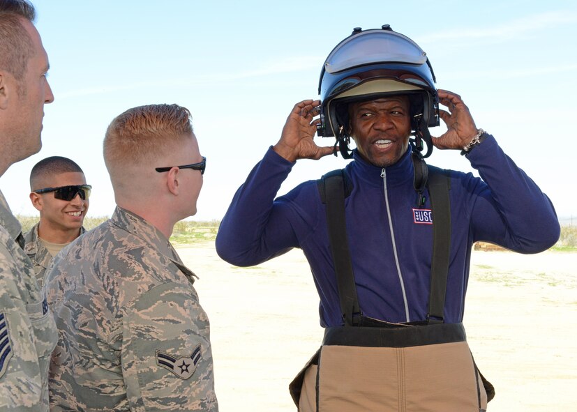 Actor Terry Crews gets to put on a bomb-protection suit and helmet with the help of Airmen from the 812th Civil Engineering Squadron, Explosive Ordnance Disposal Flight, Feb. 24.  (U.S. Air Force photo by Kenji Thuloweit)