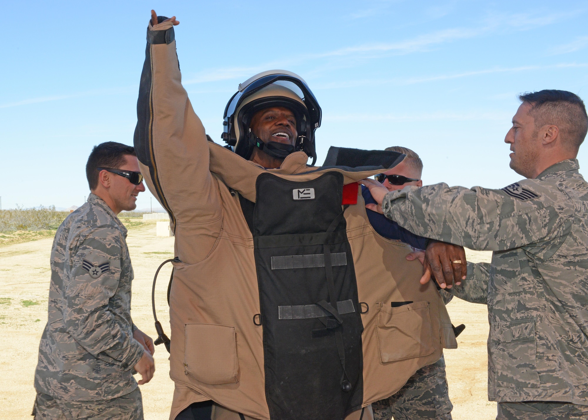 Actor Terry Crews gets to put on a bomb-protection suit with the help of Airmen from the 812th Civil Engineering Squadron, Explosive Ordnance Disposal Flight, Feb. 24.  (U.S. Air Force photo by Kenji Thuloweit)