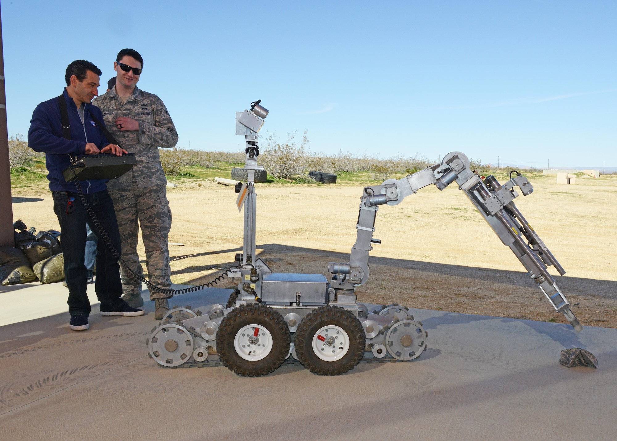 “Ultimate Beastmaster” executive producer David Broome, operates a robot from the 812th Civil Engineering Squadron, Explosive Ordnance Disposal Flight, with the guidance of bomb technician, Senior Airman Joseph Connors, Feb. 24.  (U.S. Air Force photo by Kenji Thuloweit)