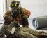 A firefighter with the 96th Civil Engineer Group, checks the condition of a U.S. Army 7th Special Forces Group (A)  participant during an exercise Feb. 23 at Eglin Air Force Base, Fla. The simulated detonation scenario tested firefighters, security forces and medical emergency response personnel agencies among others. (U.S. Air Force photo/Ilka Cole) 