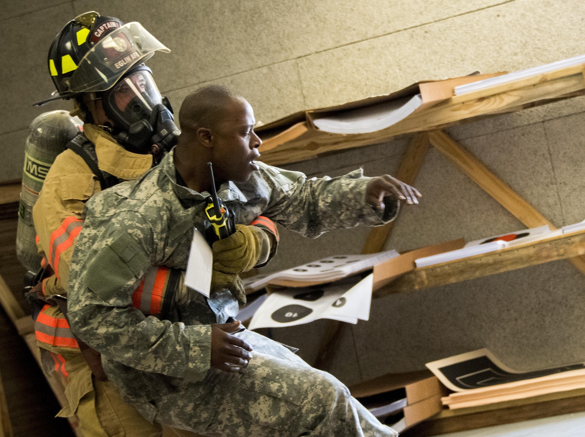 A firefighter with the 96th Civil Engineer Group, drags a U.S. Army 7th Special Forces Group (A) participant to safety during an exercise Feb. 23 at Eglin Air Force Base, Fla. The simulated detonation scenario tested firefighters, security forces and medical emergency response personnel agencies among others. (U.S. Air Force photo/Ilka Cole)