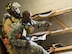 A firefighter with the 96th Civil Engineer Group, drags a U.S. Army 7th Special Forces Group (A) participant to safety during an exercise Feb. 23 at Eglin Air Force Base, Fla. The simulated detonation scenario tested firefighters, security forces and medical emergency response personnel agencies among others. (U.S. Air Force photo/Ilka Cole)