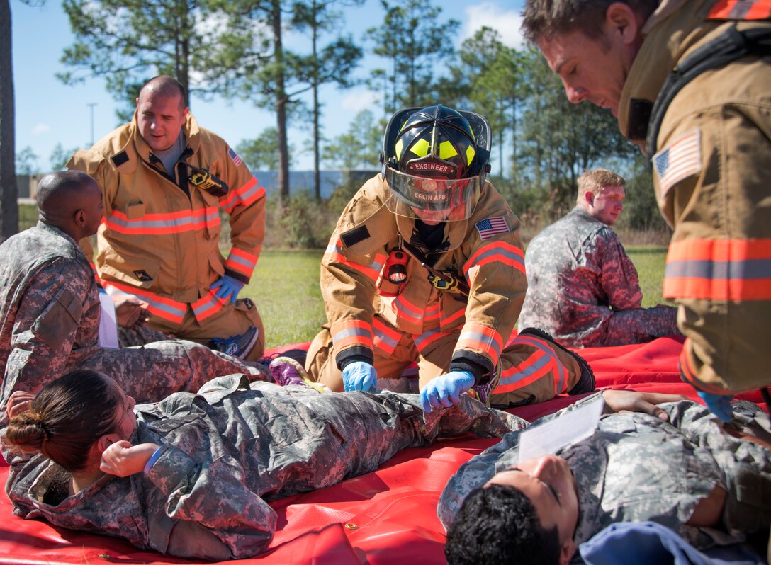Firefighters with the 96th Civil Engineer Group, evaluate and treat U.S. Army 7th Special Forces Group (A) participants after a simulated decontamination process Feb. 23 during an exercise at Eglin Air Force Base, Fla. The simulated detonation scenario tested firefighters, security forces and medical emergency response personnel agencies among others. (U.S. Air Force photo/Ilka Cole) 