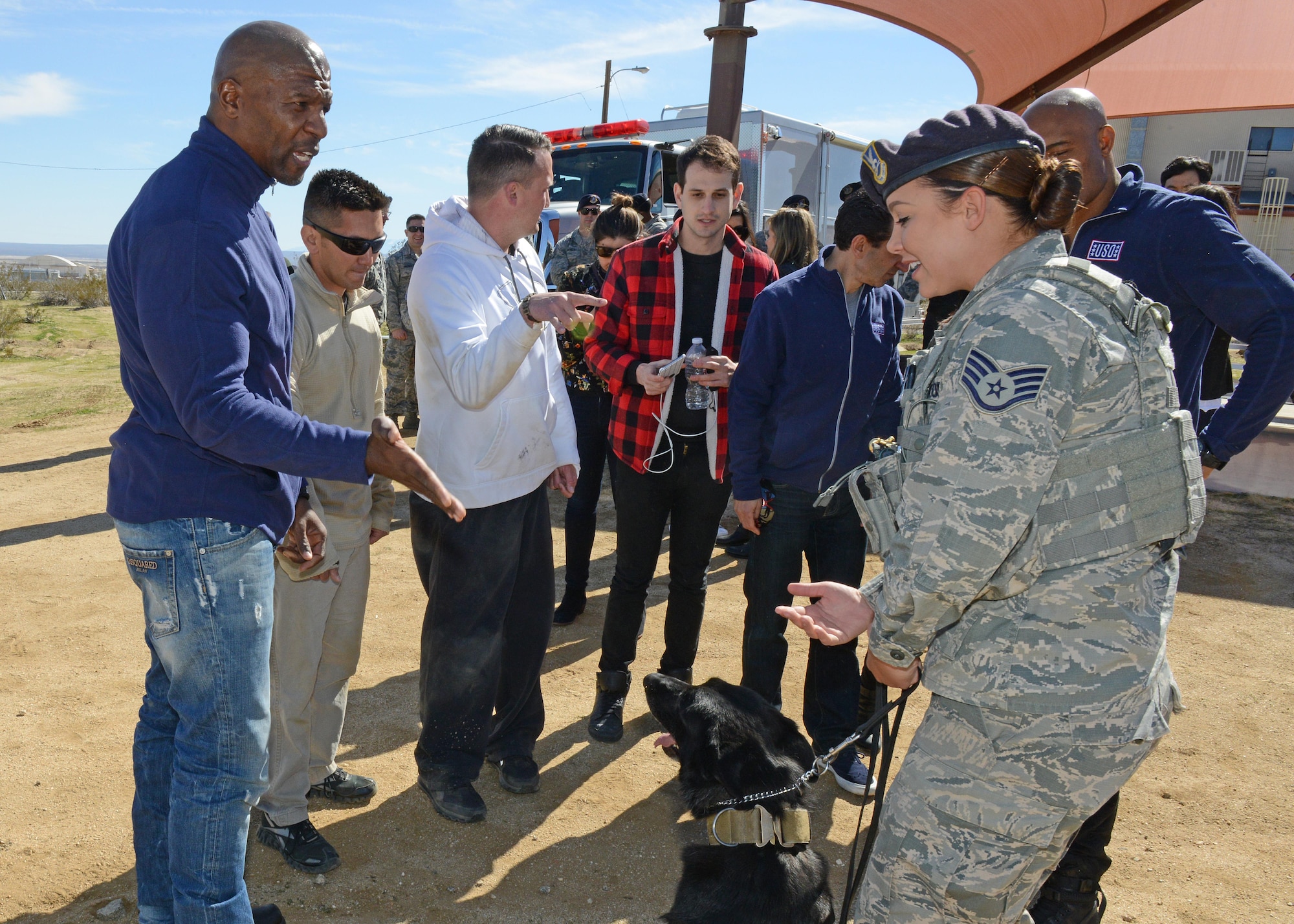 Actor and "Ultimate Beastmaster" host Terry Crews talks with Staff Sgt. Grace Daniels, 412th Security Forces Squadron, following a military working dog demonstration Feb. 24. (U.S. Air Force photo by Kenji Thuloweit)