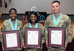 Staff Sgt. Magalie Atilus, Sgt. 1st Class Debbie Laster and Sgt. 1st Class Daniel Cummings pose with their inductions certificates for the Sergeant Major of the Army Leon L. Autreve Chapter of the Sergeant Audie Murphy Club at a ceremony at the Evans Theater at Joint Base San Antonio-Fort Sam Houston March 1. All three Soldiers are members of the 32nd Medical Brigade. 