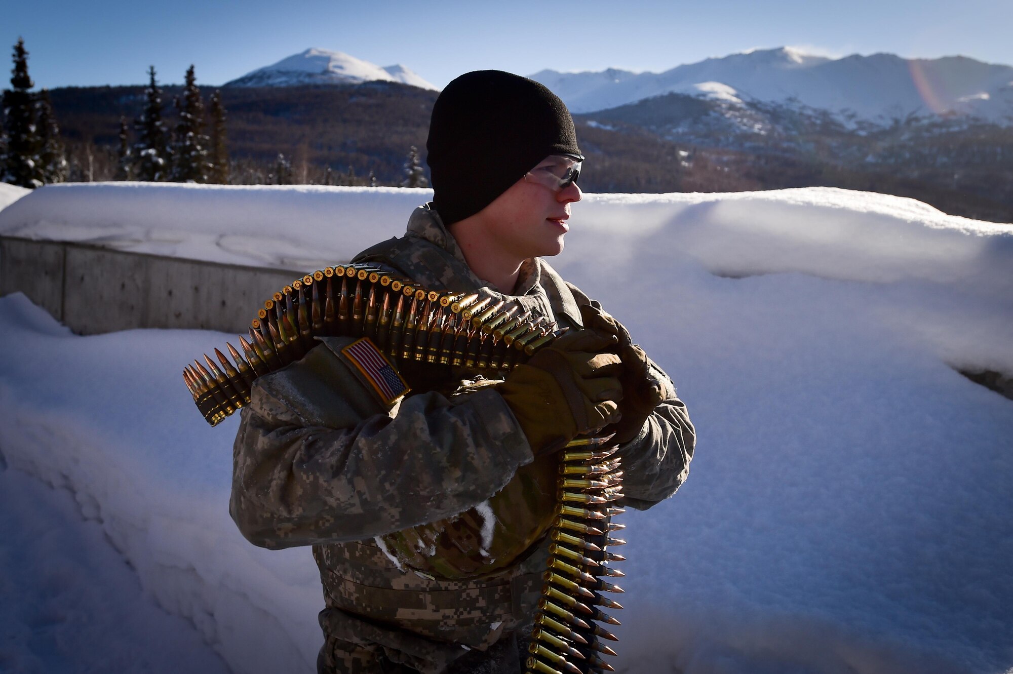 A paratrooper assigned the 4th Infantry Brigade Combat Team (Airborne), 25th Infantry Division, U.S. Army Alaska, carries ammunition to a firing point during qualification with M240B machine guns and Mark 19 40mm grenade machine guns on Grezelka range at Joint Base Elmendorf-Richardson, Alaska, Feb 28, 2017. U.S. Army Alaska is home to the Army’s only Pacific airborne brigade combat team, and maintains the only airborne rapid-response capacity within the Pacific Command. (U.S. Air Force photo/Justin Connaher)