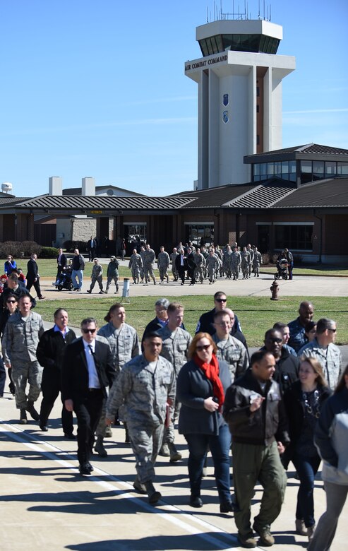 Service members and their families make their way to the Langley Air Force Base flightline to greet U.S. President Donald J. Trump at Joint Base Langley-Eustis, Va., March 2, 2016. The president arrived and departed from the flight line of the 1st Fighter Wing, the U.S. Air Force’s premiere air dominance wing led by next generation Airmen, who fly, maintain and support one third of the U.S. Air Force's combat F-22 Raptors.  (U.S. Air Force photo by Staff Sgt. Natasha Stannard)