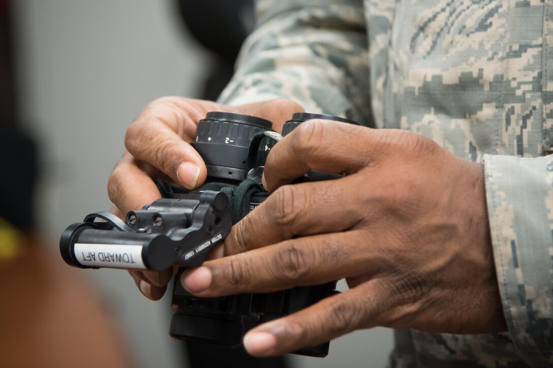 Master Sgt. Ray Reynolds, 403rd Operations Support Squadron aircrew flight equipment supervisor, adjusts a pair of night vision goggles Feb. 22 at Keesler Air Force Base, Mississippi. (U.S. Air Force photo/Staff Sgt. Heather Heiney)