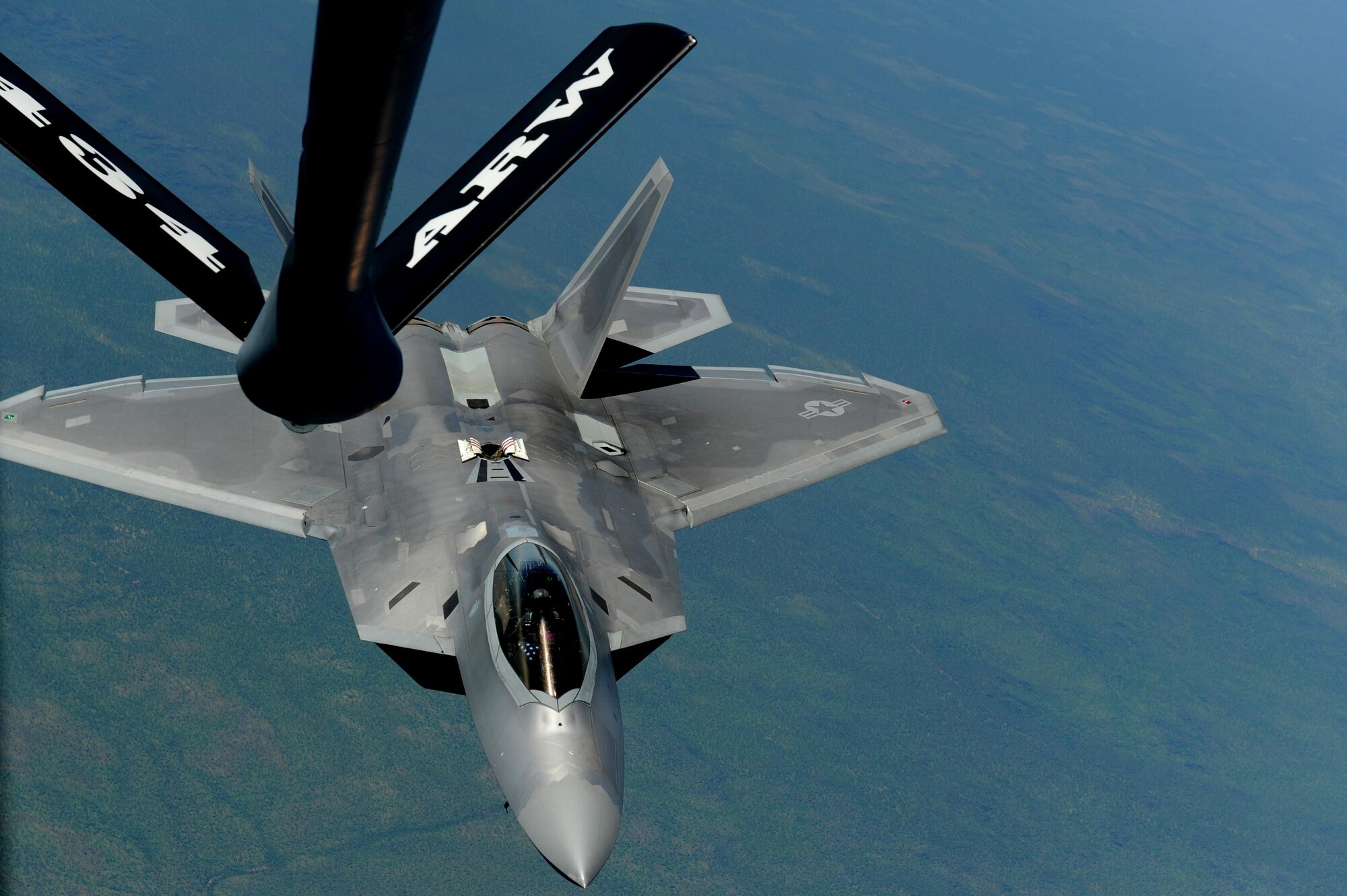 A U.S. Air Force F-22 Raptor assigned to the 90th Fighter Squadron approaches a U.S. Air Force KC-135 Stratotanker in order to receive fuel in the skies above Royal Australian Air Force Base Tindal, Australia, March 2, 2017. Twelve F-22 Raptors and approximately 200 U.S. Air Force Airmen participated in the first Enhanced Air Cooperation, an initiative under the Force Posture Agreement between the U.S. and Australia. (U.S. Air Force photo by Staff Sgt. Alexander Martinez)