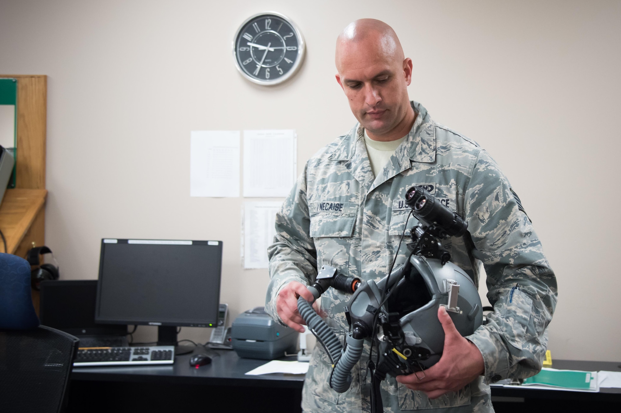 Staff Sgt. Justin Necaise, 403rd Operations Support Squadron survival technician attaches night vision goggles to a flight helmet Feb. 22 at Keesler Air Force Base, Mississippi. (U.S. Air Force photo/Staff Sgt. Heather Heiney) 