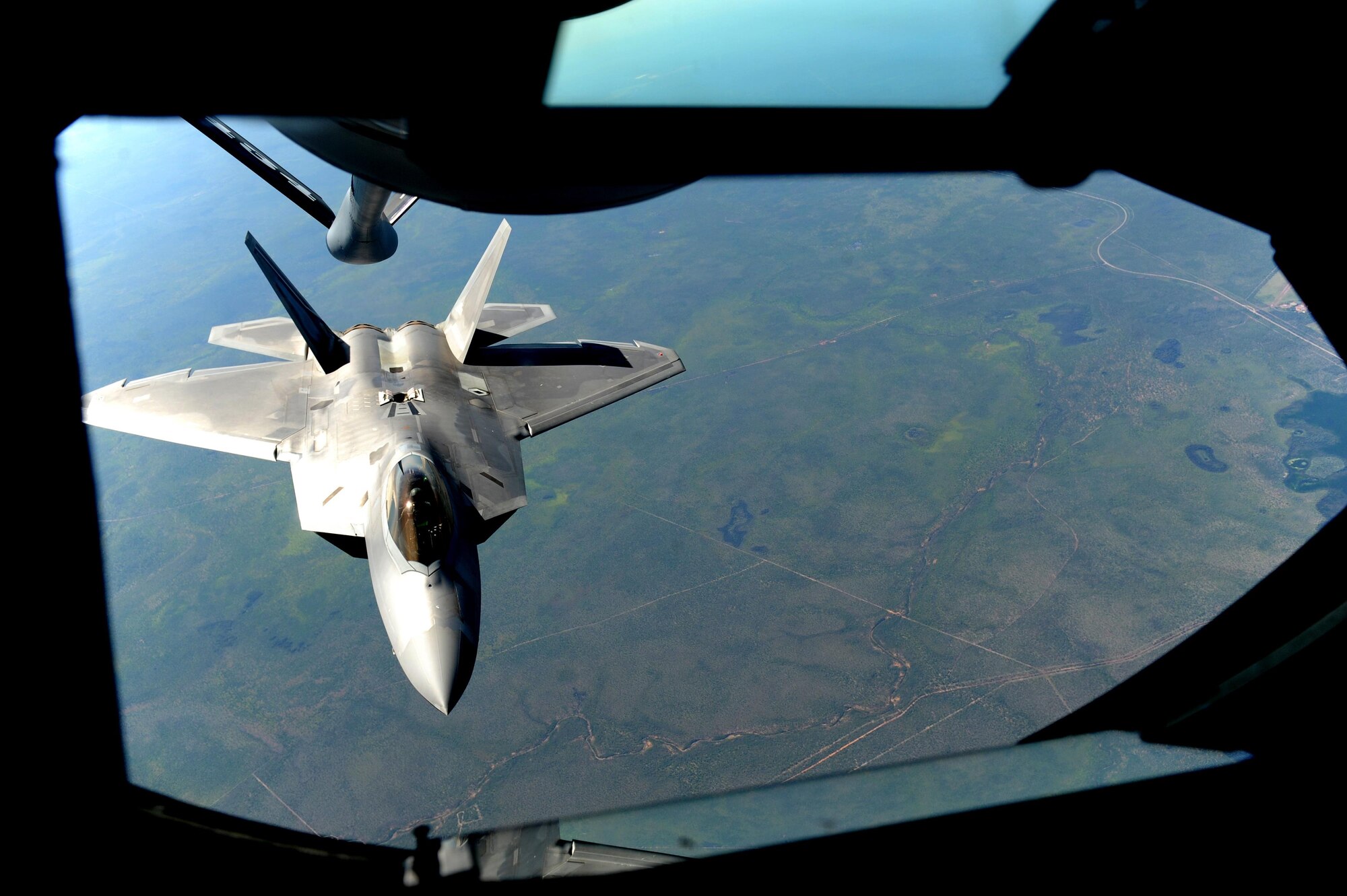 A U.S. Air Force F-22 Raptor assigned to the 90th Fighter Squadron approaches a U.S. Air Force KC-135 Stratotanker in order to receive fuel in the skies above Royal Australian Air Force Base Tindal, Australia, March 2, 2017. Twelve F-22 Raptors and approximately 200 U.S. Air Force Airmen participated in the first Enhanced Air Cooperation, an initiative under the Force Posture Agreement between the U.S. and Australia. (U.S. Air Force photo by Staff Sgt. Alexander Martinez)