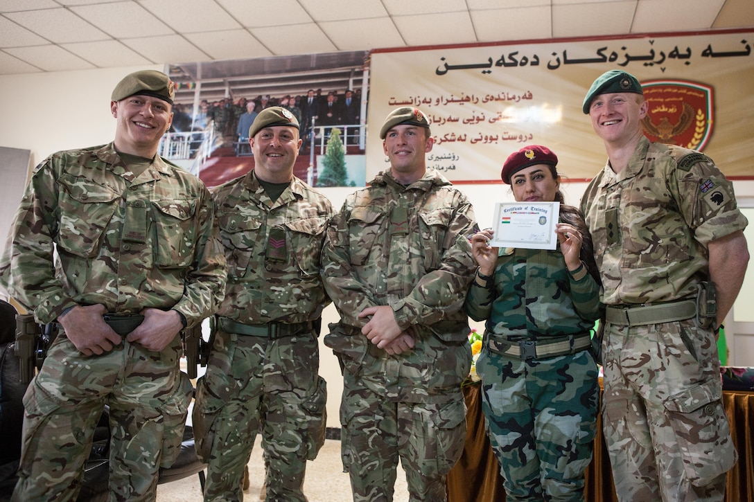 A Zeravani soldier displays her training certificate with her British trainers after a graduation ceremony near Erbil, Iraq, Feb. 16, 2017. The training, which included movement on urban terrain, basic marksmanship, vehicle search and other soldier skills, is part of the overall Combined Joint Task Force – Operation Inherent Resolve building partner capacity mission by training and improving the capability of partnered forces fighting ISIS. CJTF-OIR is the global Coalition to defeat ISIS in Iraq and Syria. (U.S. Army photo by Sgt. Josephine Carlson)