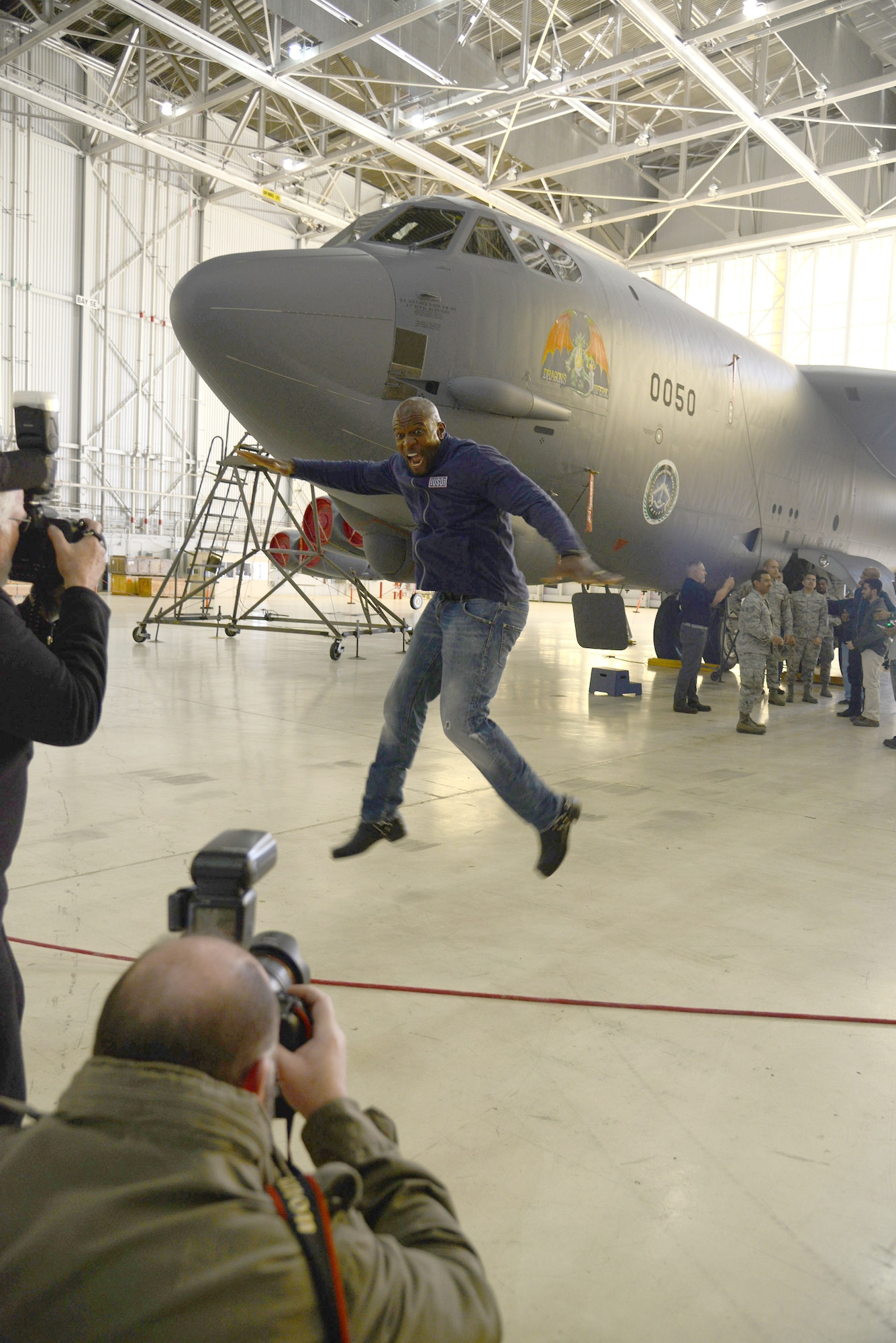 Actor Terry Crews jumps at the chance for photos while visiting Hangar 1600 Feb. 24. (U.S. Air Force photo by Christopher Ball)