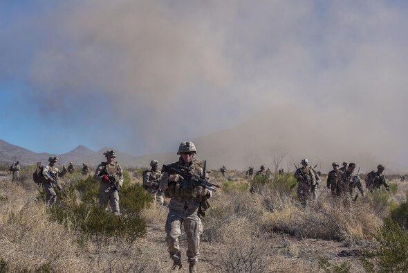 Marines from I Marine Expeditionary Force from Camp Pendleton, Calif., advance the desert during a simulated Tactical Recovery of Aircraft and Personnel scenario, Feb. 22, 2017, at the Playas Training and Research Center, N.M. During the scenario, the I MEF rescued isolated personnel from a downed aircraft while fending off mock opposition forces from the 563rd Operations Support Squadron, Davis-Monthan Air Force Base, Ariz. (U.S. Air Force photo/Airman 1st Class Greg Nash)