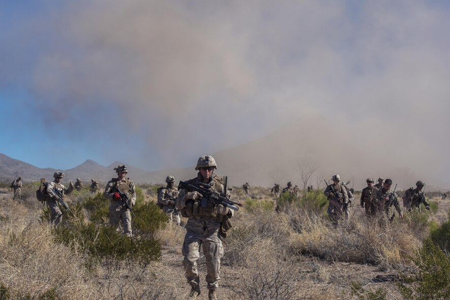 Marines from I Marine Expeditionary Force from Marine Corps Base Camp Pendleton, Calif., advance the desert during a simulated Tactical Recovery of Aircraft and Personnel scenario, Feb 22, 2017, at the Playas Training and Research Center, N.M. During the scenario, the IMEF rescued isolated personnel from a downed aircraft while fending off mock opposition forces from Davis-Monthan Air Force Base, Ariz.’s 563d Operations Support Squadron. This joint effort prepared the IMEF by completing their Special Purpose Marine Air Ground Task Force certification. This is the culmination of their crisis response operations before deploying to the United States Central Command, which consists of 20 countries In Northeast Africa and Southwest Asia. (U.S. Air Force photo by Airman 1st Class Greg Nash)   