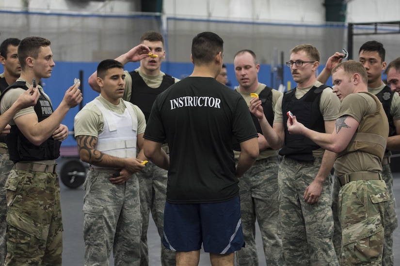 Staff Sgt. Damien Hernandez, 811th Security Forces Squadron executive aircraft security member and instructor, ensures Fly-Away Security Team training participants have their mouth guards at Joint Base Andrews, Md., Feb. 24, 2017. The course, nicknamed “Pre-Raven,” occurred from Feb. 13 to March 2, where security forces and military police military members were trained to perform fly-away mission duties at JBA. Ravens are specially trained security forces personnel who provide executive aircraft security to Air Force assets. (U.S. Air Force photo by Senior Airman Jordyn Fetter)