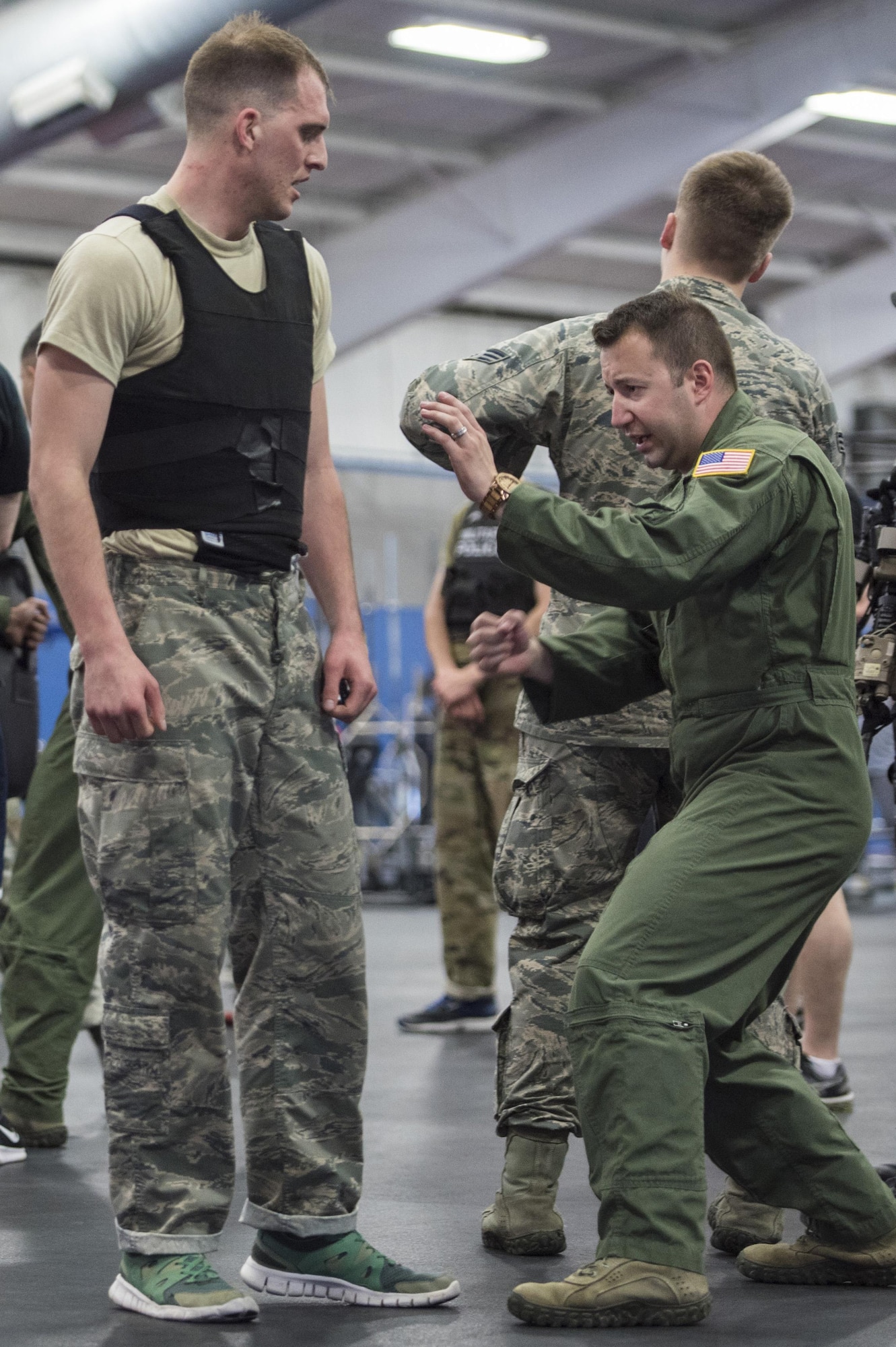 Tech. Sgt. Channing Pompa, 811th Security Forces Squadron executive aircraft security team leader, right, talks to Senior Airman Paul Pfenning, Fly-Away Security Team training participant, left, after a Redman fight during Fly-Away Security Team training, nicknamed “Pre-Raven,” at Joint Base Andrews, Md., Feb. 24, 2017. This quarterly-held course determines whether applicants can perform the Raven mission of providing discrete, low‐visibility security that ensures protection for Air Force aircraft transiting airfields where security is unknown or deemed inadequate to counter local threats. (U.S. Air Force photo by Senior Airman Jordyn Fetter)