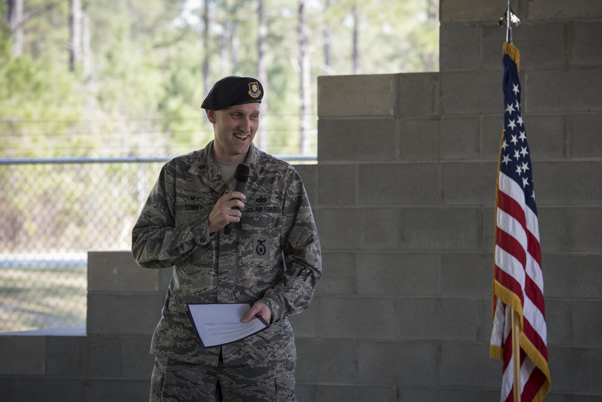 Maj. Charles Tenney, 23d Security Forces Squadron commander, shares memories about military working dog Ssmokey during a MWD leash transfer ceremony, Feb. 28, 2017, at Moody Air Force Base, Ga. Ssmokey was transferred from the care of Staff Sgt. Jason Ashmore, 23d SFS MWD trainer, to Officer Jose Cruz, VPD K-9 handler, where he will continue his work as an explosive detective dog in the local community. (U.S. Air Force photo by Airman 1st Class Lauren M. Sprunk)