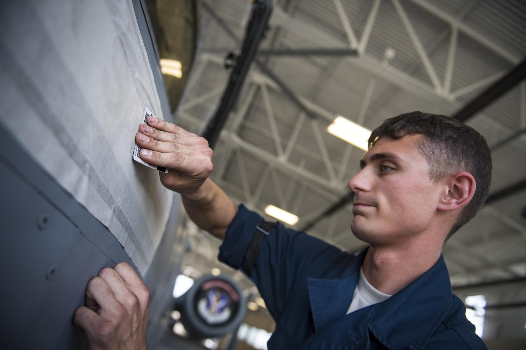 Senior Airman Michael Verheyden,74th Aircraft Maintenance Unit dedicated crew chief, applies a nametape to assign the A-10C Thunderbolt II in the Weapons Load Training hangar to the late Staff Sgt. Sara Toy, 74th AMU weapons team chief, Feb. 27, 2017, at Moody Air Force Base, Ga. Team Moody’s weapons community wanted to honor Toy, who died in a motor vehicle accident on Feb. 25, 2017, by dedicating the aircraft used for training and certifying all weapons load crew members. (U.S. Air Force photo by Andrea Jenkins/Released)