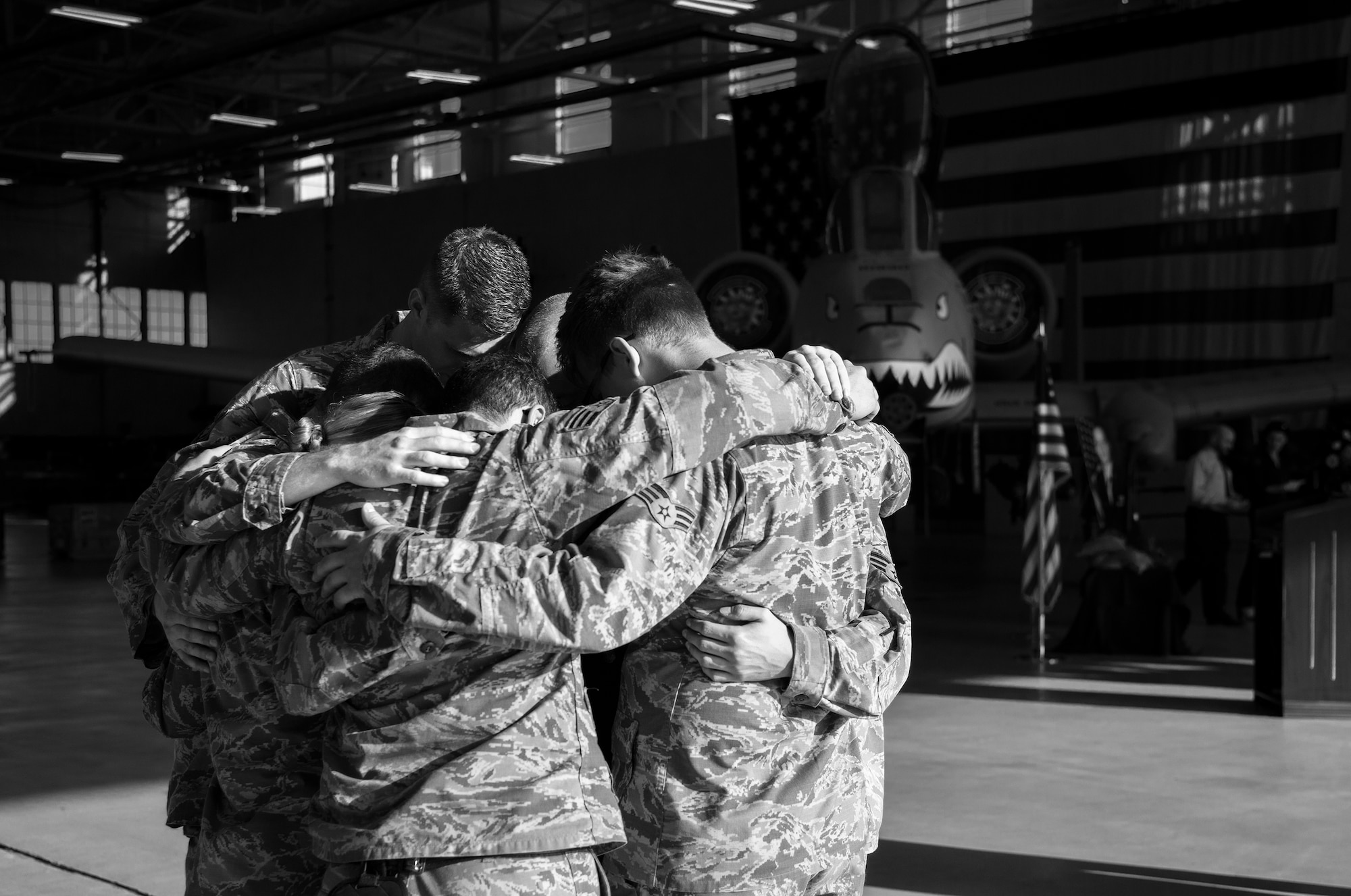 Senior Airman Lucus Zeman, 23d Equipment Maintenance Squadron, and fellow maintainers share an embrace during a memorial ceremony in honor of his late wife, Staff Sgt. Sara Toy, 74th Aircraft Maintenance Unit weapons team chief, March 1, 2017, at Moody Air Force Base, Ga. Toy, a New Kent, Virginia native, died in a car accident Feb. 25, 2017. During the ceremony, she was remembered as a valuable member of the Team Moody weapons community and was posthumously awarded the Air Force Commendation Medal and the rank of Staff Sergeant. (U.S. Air Force photo by Andrea Jenkins/Released)