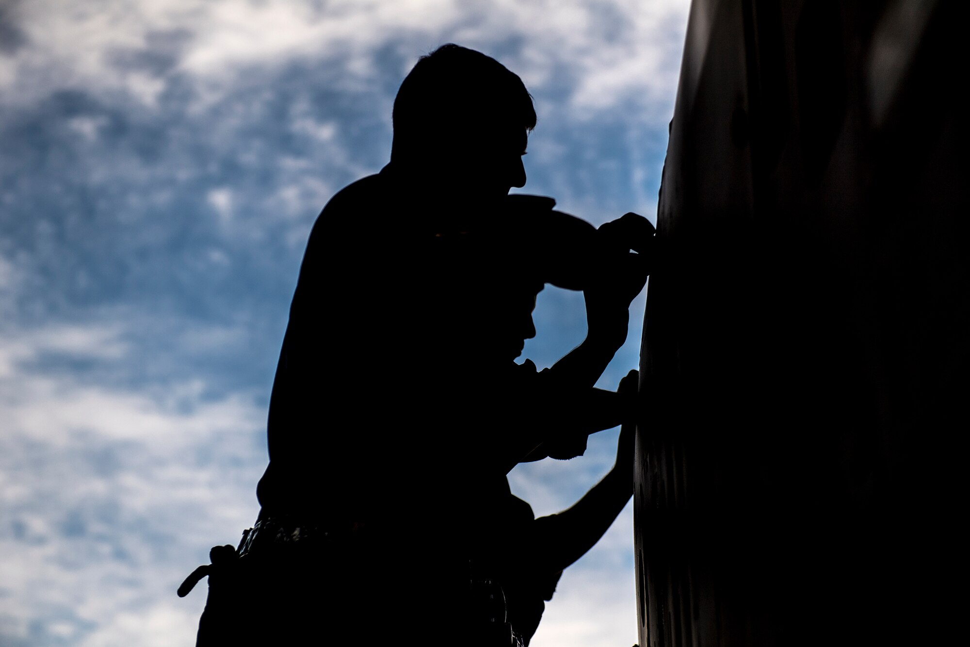 Senior Airmen Kyle Baker and Michael Verheyden, 74th Aircraft Maintenance Unit dedicated crew chiefs, apply a nametape to assign the A-10C Thunderbolt II in the Weapons Load Training hangar to the late Staff Sgt. Sara Toy, 74th AMU weapons team chief, Feb. 27, 2017, at Moody Air Force Base, Ga. Team Moody’s weapons community wanted to honor Toy, who died in a motor vehicle accident on Feb. 25, 2017, by dedicating the aircraft used for training and certifying all weapons load crew members. (U.S. Air Force photo by Andrea Jenkins/Released)