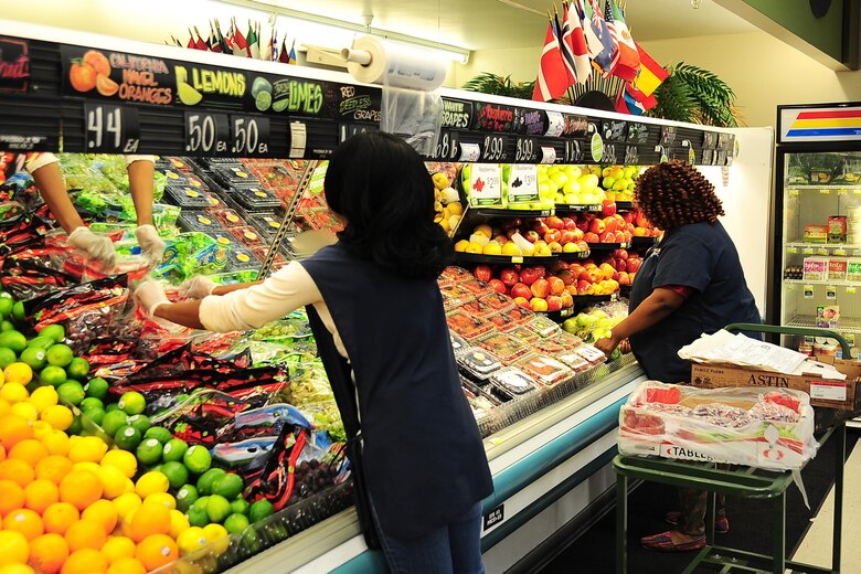 Quintina Walters, Store Associate, and Valandria James, Store Worker, stock produce March 1, 2017, at Columbus Air Force Base, Mississippi. Upcoming changes include replacing all refrigeration on the sales floor to include deli, produce and meat department cases. (U.S. Air Force photo by Senior Airman Kaleb Snay)