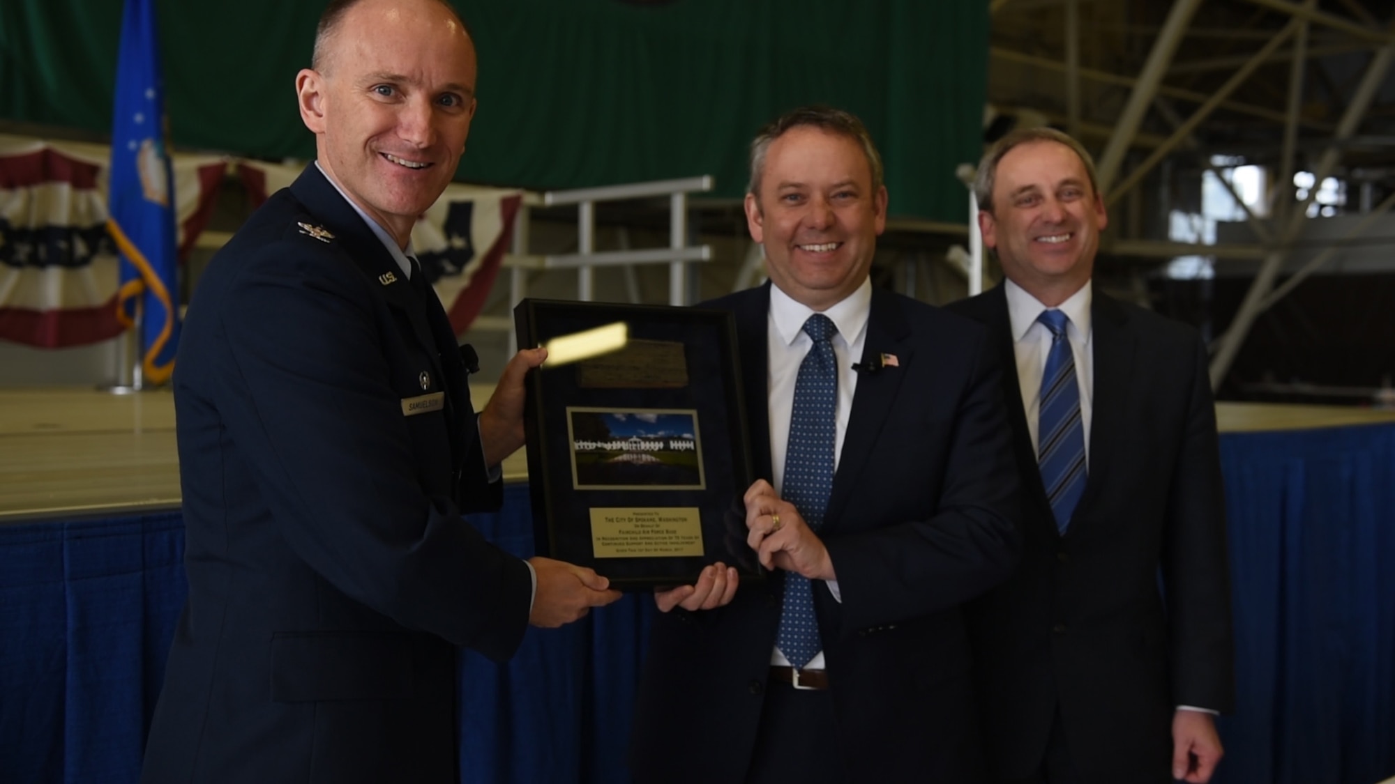 Col. Ryan Samuelson, 92nd Air Refueling Wing commander, Spokane Mayor David Condon and Todd Mielke, Greater Spokane Incorporated CEO pose for a photo during the 75th Anniversary of Fairchild Air Force Base March, 1, 2017, at Fairchild Air Force Base, Wash. Samuelson presented Condon with a tile from the old headquarters building as a symbol of the strong ties and support received from Condon and the community as a whole. (U.S. Air Force photo/Tech Sgt. Monique Jose Duvall)