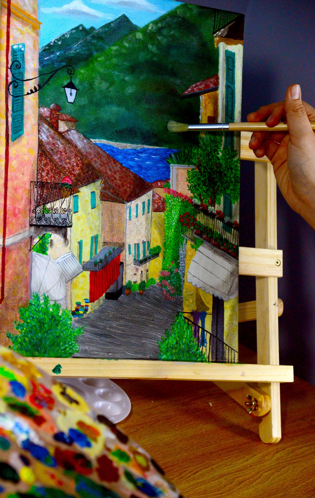 Airman 1st Class Yoli Alvarez Hernandez, 341st Medical Operations Squadron mental health technician, recreates an Italian community with oil paints Feb. 28, 2017, at the dorm complex at Malmstrom Air Force Base, Mont. Using oil-based paint to create works of art allow an artist to blend colors together for a seamless gradient. (U.S. Air Force photo/Airman 1st Class Magen M. Reeves)