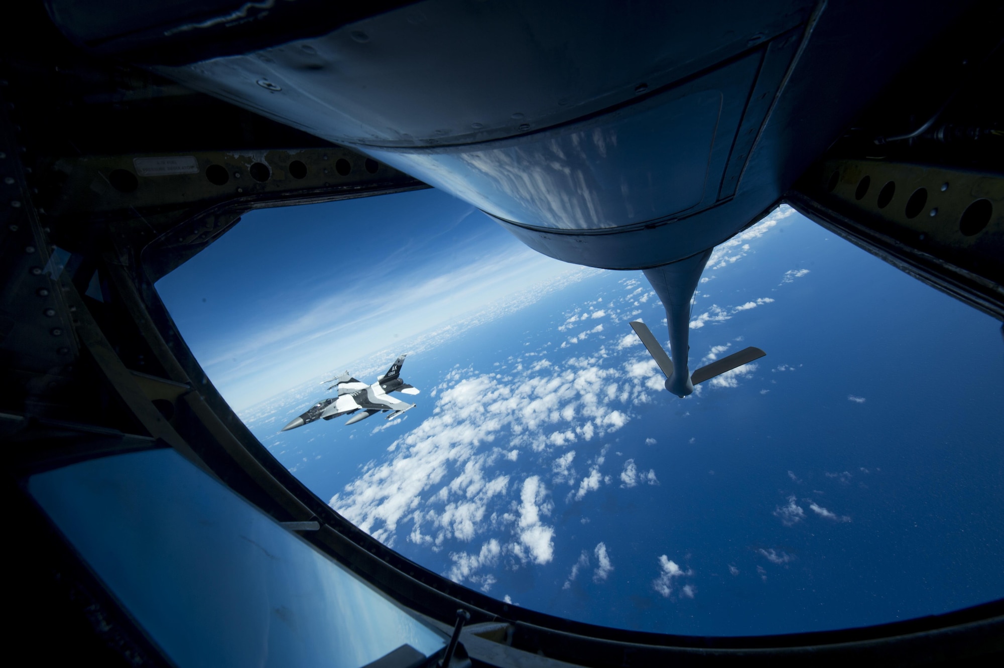 A U.S. Air Force F-16 Fighting Falcon assigned to the 18th Aggressor Squadron banks right after recieving in-flight fuel from a U.S. Air Force KC-135 Stratotanker during Cope North 17, March 2, 2017. The exercise includes 22 total flying units and more than 2,700 personnel from three countries and continues the growth of strong, interoperable relationships within the Indo-Asia-Pacific region through integration of airborne and land-based command and control assets. (U.S. Air Force photo by Staff Sgt. Keith James)