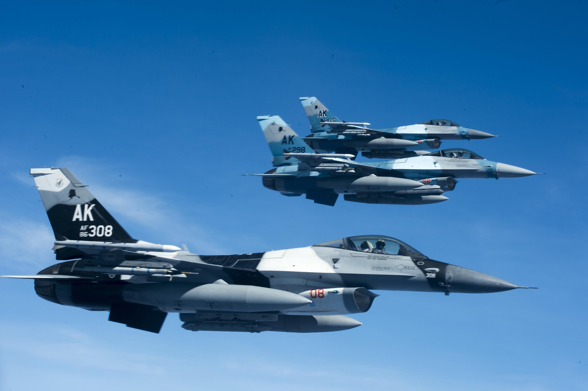 A three-ship formation of U.S. Air Force F-16 Fighting Falcons assigned to the18th Aggressor Squadron fly alongside a U.S. Air Force KC-135 Stratotanker and wait to receive in-flight fuel during Cope North 17, March 2, 2017. The exercise includes 22 total flying units and more than 2,700 personnel from three countries and continues the growth of strong, interoperable relationships within the Indo-Asia-Pacific region through integration of airborne and land-based command and control assets. (U.S. Air Force photo by Staff Sgt. Keith James)