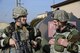 Col. Andrew Hansen (right), 51st Fighter Wing commander, and Staff Sgt. Bradley Booker (left), 51st Security Forces member discuss security forces responses as part of a simulated kidnapping of the wing commander during Exercise Beverly Herd 17-1 at Osan Air Base, Republic of Korea, March 3, 2017. Defenders verified the suspect vehicle and searched the perimeter of the building where the vehicle was found. (U.S. Air Force photo by Airman 1st Class Gwendalyn Smith)