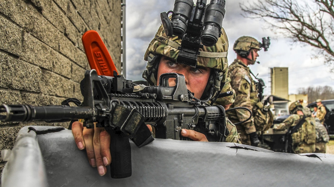 Army Pfc. Andy Farley, a paratrooper, assumes a security position during a tactical exercise at the Muscatatuck Urban Training Complex in North Vernon, Ind., Feb. 24, 2017. Army Pfc. Houston Graham
