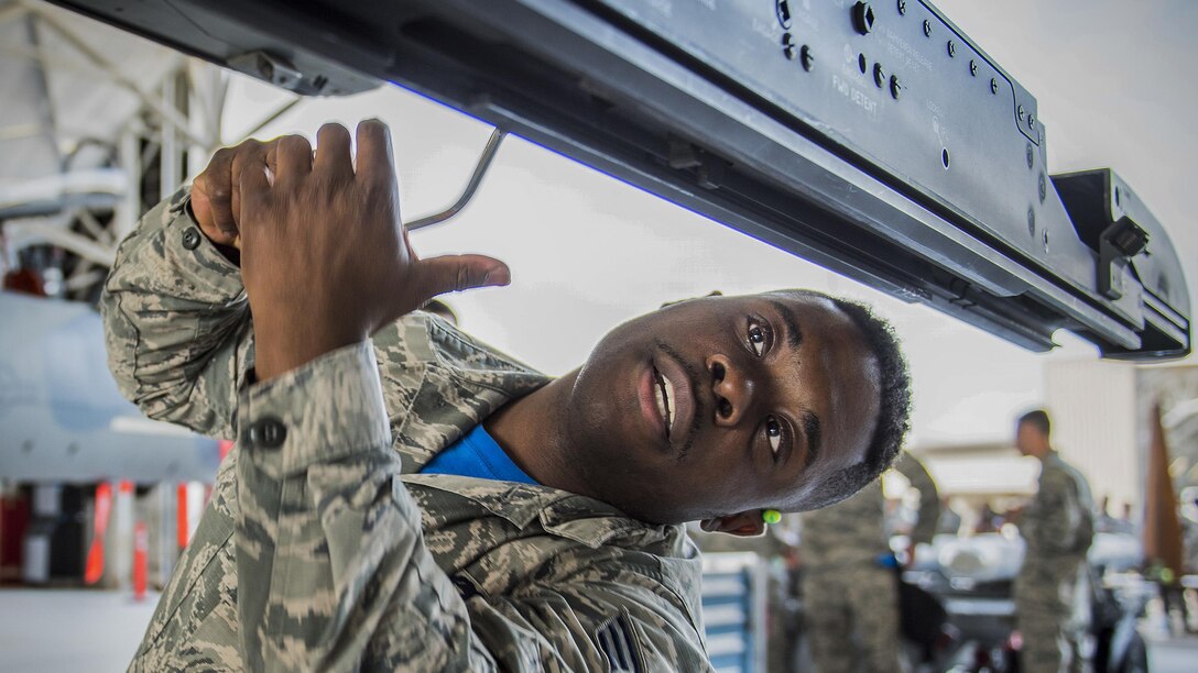 Air Force Senior Airman David Johnson prepares an F-16 missile rail for an AIM-9 missile during a weapons load competition at Eglin Air Force Base, Fla., Feb. 17, 2017. Air Force photo Ilka Cole