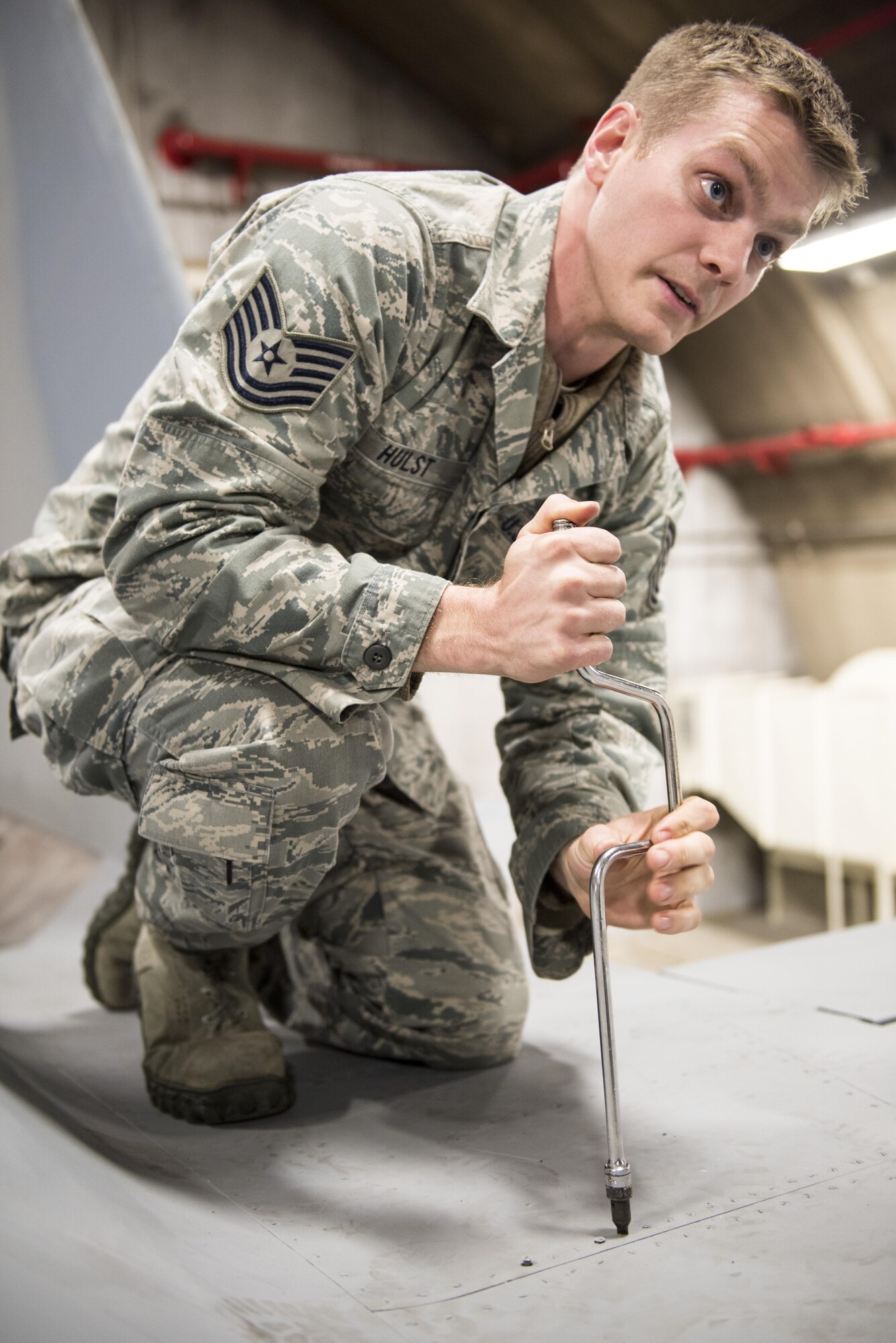 U.S. Air Force Tech. Sgt. Michael Hust, 44th Aircraft Maintenance Unit lead electrical and environmental specialist, demonstrates how to remove a panel from an F-15A Eagle Feb. 28, 2017, at Kadena Air Base, Japan. Hust helps instruct new electrical and environmental maintainers for the 18th Maintenance Training Flight’s new ENE core tasks course. (U.S. Air Force photo by Senior Airman Omari Bernard/Released)