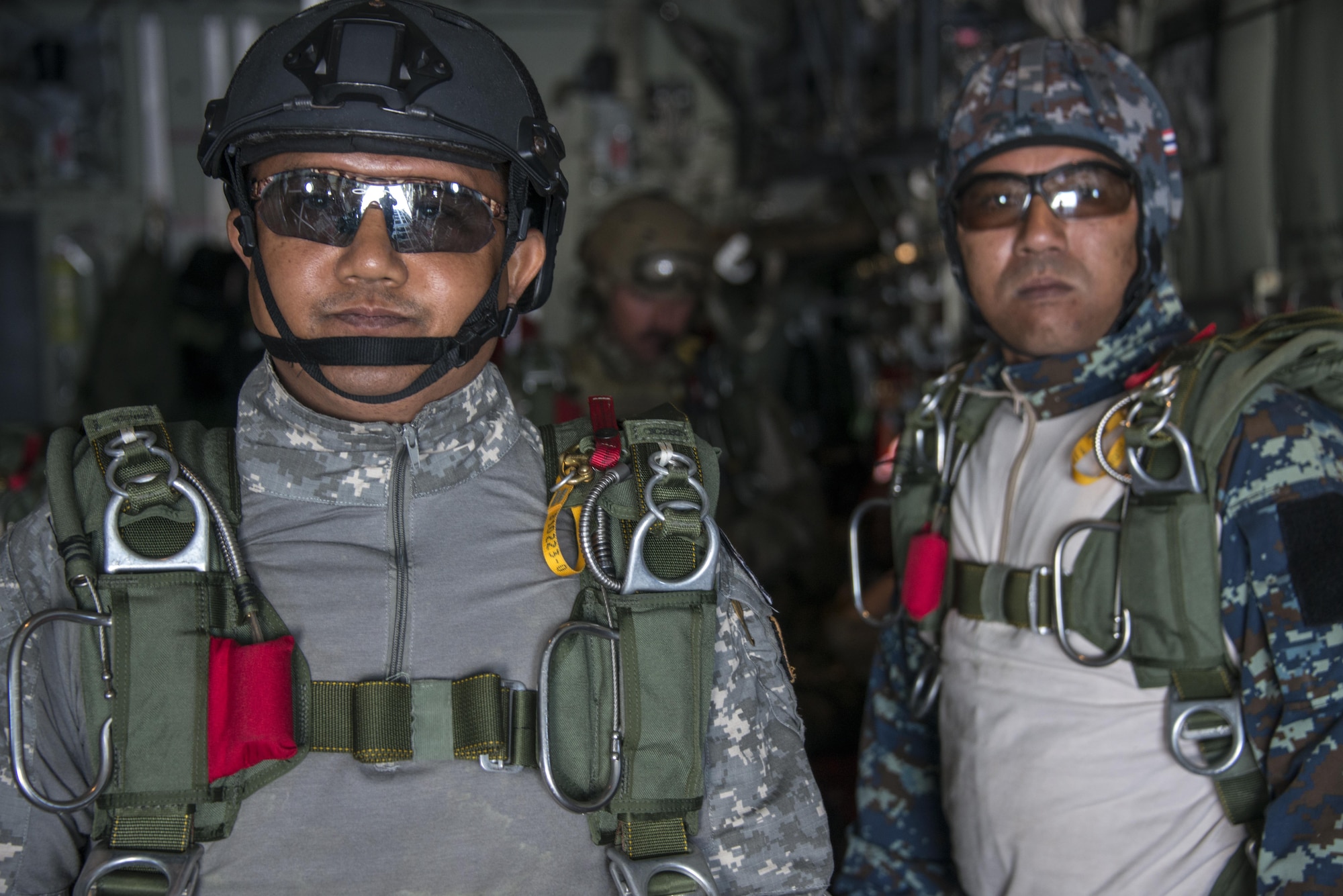 Royal Thai Air Force Special Operations Regiment combat controllers and pararescuemen prepare to jump from a U.S. Air Force MC-130J Commando II assigned to the 17th Special Operations Squadron, Feb. 20, 2017 at Korat Air Base, Thailand. Executing jump operations throughout Cobra Gold 2017, the members of the 320th Special Tactics Squadron and RTAF SOR demonstrated the strength of a partnership that has evolved over the last 17 years. (U.S. Air Force photo by Capt. Jessica Tait)