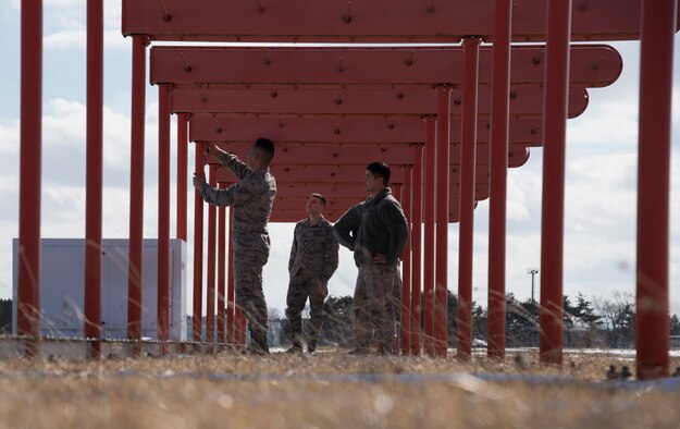 U.S. Air Force Airmen with the 35th Operations Support Squadron airfield systems section, inspect a localizer antennae at Misawa Air Base, Japan, Feb. 27, 2017. The antennae transmit signals at different phases for correct modulation. The flight ensures serviceability of airfield systems, which give a multitude of accurate readings to pilots, weather personnel and air traffic controllers. (U.S. Air Force photo by Airman 1st Class Sadie Colbert)