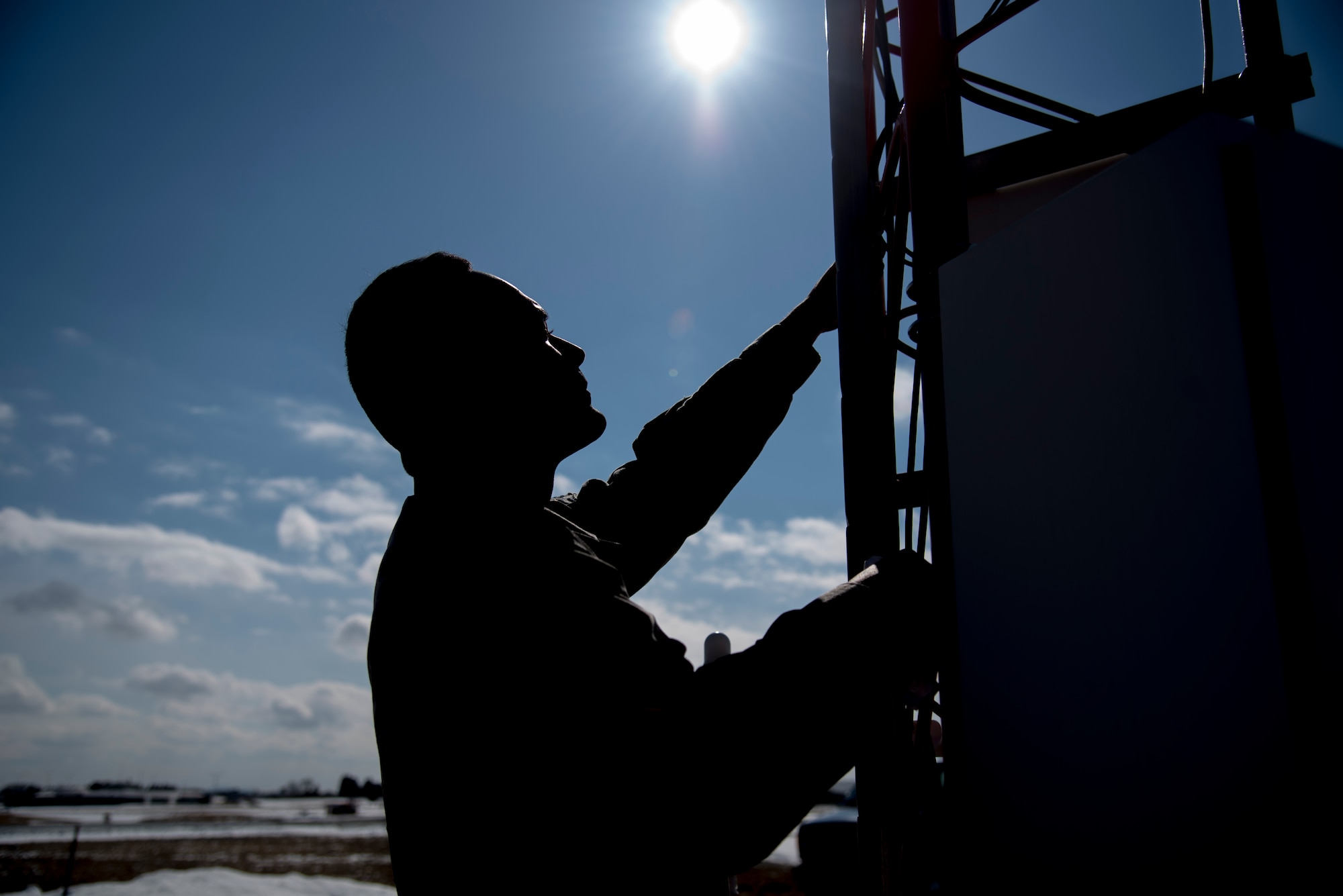 U.S. Air Force Airman 1st Class Christopher Blackwell, a 35th Operations Support Squadron airfield systems technician, climbs an AN/FMQ 19 at Misawa Air Base, Japan, Feb. 27, 2017. The AN/FMQ 19 is an integrated system of weather sensors that measure, collect and disseminate meteorological data to help pilots, weather personnel and air traffic controllers prepare and monitor weather forecasts. By Airfield systems Airmen enable, F-16 Fighting Falcons to contribute to Pacific Air Forces’ mission to deter aggression with allies and maintain peace and stability in the Indo-Asia- Pacific region. (U.S. Air Force photo by Airman 1st Class Sadie Colbert)