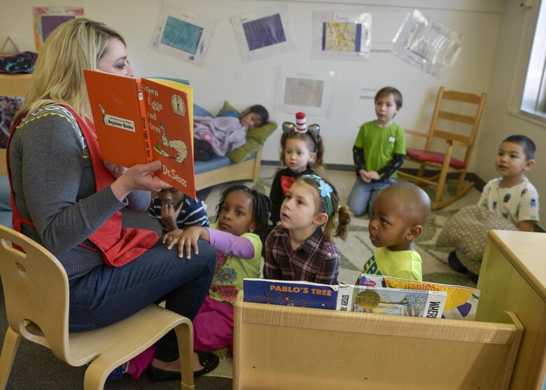 Heather Barry, an education technician at Yoiko Child Development Center, reads “Green Eggs and Ham” by Dr. Seuss prior to eating breakfast at Misawa Air Base, Japan, March 2, 2017. The CDC celebrated Read Across America with a Spirt Week that encouraged children to wear a specific attire each day including pajamas, Cat in the Hat, mismatched outfits, something green and a Dr. Seuss inspired costume.(U.S. Air Force photo by Staff Sgt. Melanie A. Hutto)
