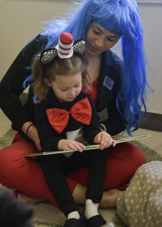 Marilyn Vega-Maldonado, assistant director with the Yoiko Child Development Center, and her daughter, Karina, read a book prior to eating a “Green Eggs & Ham” themed breakfast at Misawa Air Base, Japan, March 2, 2017. The day, March 2, is known nationally as Read Across America, a day dedicated to promoting and celebrating reading. (U.S. Air Force photo by Staff Sgt. Melanie A. Hutto)