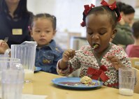 Kaiya, daughter of Maj. Kawana Rawls, a flight commander with the 35th Surgical Operations Squadron, eats green eggs as part of the Child Development Center’s celebration for Read Across America at Misawa Air Base, Japan, Mar. 2, 2017. The purpose of Read Across America is to bring excitement to reading for children of all ages. (U.S. Air Force photo by Staff Sgt. Melanie A. Hutto)