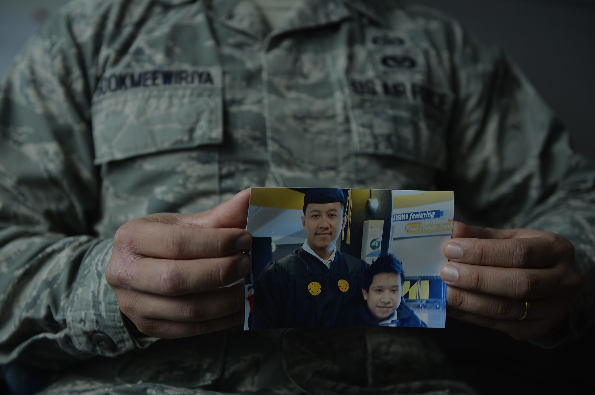 Staff Sgt. Srun Sookmeewiriya, 313th Expeditionary Operations Support Squadron NCO in charge of reports, holds up a picture of him and his younger brother, Thana, on Ramstein Air Base, Germany, Feb. 16, 2017. Sookmeewiriya, who attempted to commit suicide twice, draws inspiration from his brother to remain resilient and encourages Airmen to open up about their struggles. (U.S. Air Force photo by Airman 1st Class Joshua Magbanua)