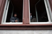 Two men peer out the windows of a bar during fasching, a festival held across Europe, in the city of Ramstein, Germany, Feb. 28, 2017. In the Middle Ages, Karneval gave people a break from the tightly structured class system, as they were able to hide their social background behind imaginative costumes and masks. (U.S. Air Force photo by Senior Airman Lane T. Plummer)