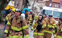 Firefighters from the Ramstein Air Base fire department walk through a parade during fasching, a festival held across Europe, in the city of Ramstein, Germany, Feb. 28, 2017. Civil workers, politicians, businessmen and more come together to crowd their streets and celebrate the coming of warmer weather. (U.S. Air Force photo by Senior Airman Lane T. Plummer)