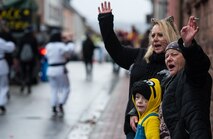 People wave at people in a parade during fasching, a festival held across Europe, in the city of Ramstein, Germany, Feb. 28, 2017. In the Middle Ages, Karneval gave people a break from the tightly structured class system, as they were able to hide their social background behind imaginative costumes and masks. (U.S. Air Force photo by Senior Airman Lane T. Plummer)