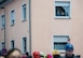 An elderly couple stare out their window to view the parade below them during fasching, a festival held across Europe, in the city of Ramstein, Germany, Feb. 28, 2017. Fasching is a time of festivity and merry making—a time where common place people take a chance to free themselves for personal expression and celebration. (U.S. Air Force photo by Senior Airman Lane T. Plummer)