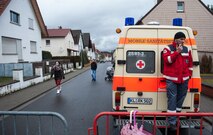 A paramedic waits besides his vehicle as he observes the parade during fasching, a festival held across Europe, in the city of Ramstein, Germany, Feb. 28, 2017. The festival season is celebrated by people from Germany, Switzerland and Austria. (U.S. Air Force photo by Senior Airman Lane T. Plummer)
